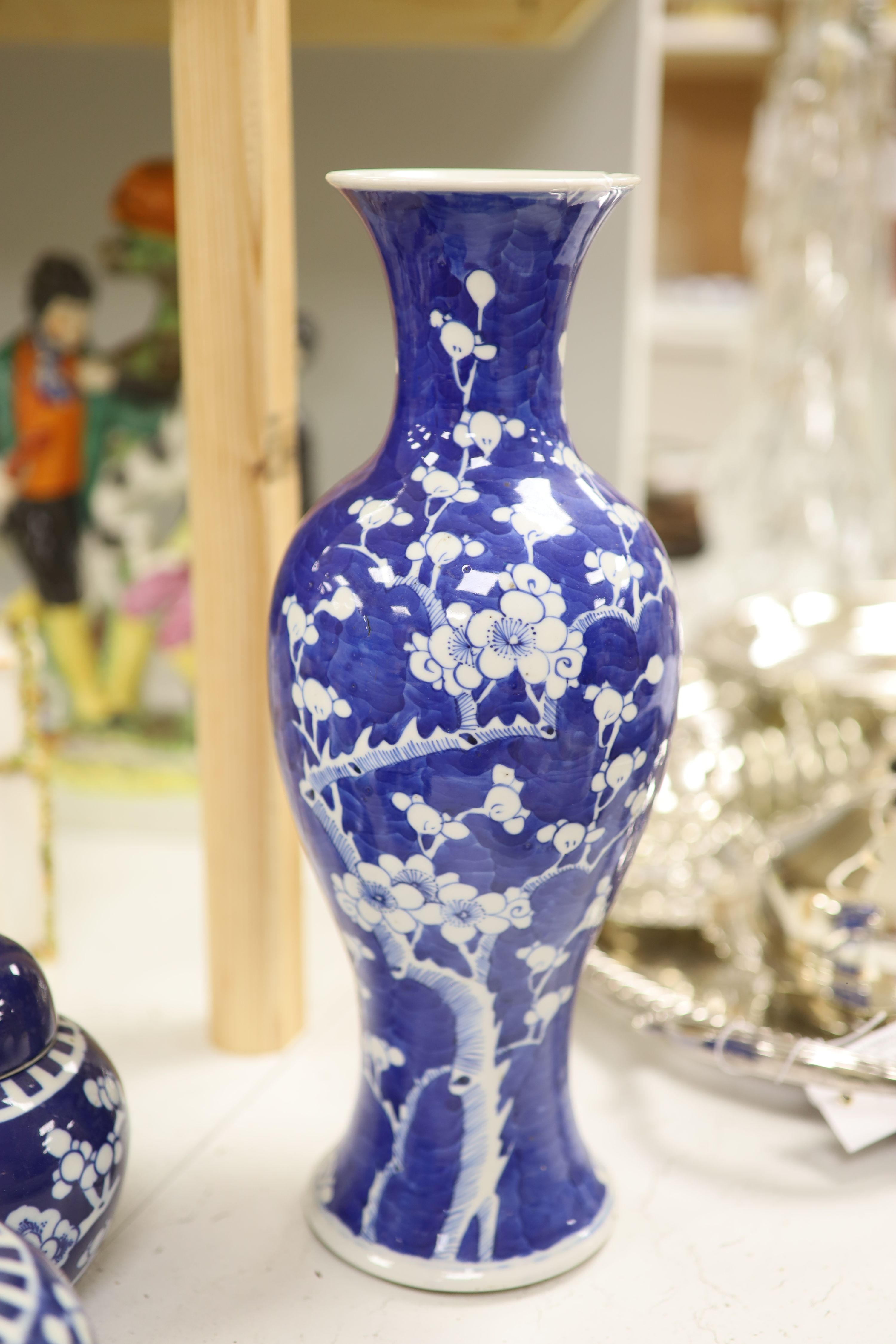 An early 20th century Chinese blue and white ‘prunus’ vase a Republic period millefleur dish, a similar Canton vase and two blue and white jars